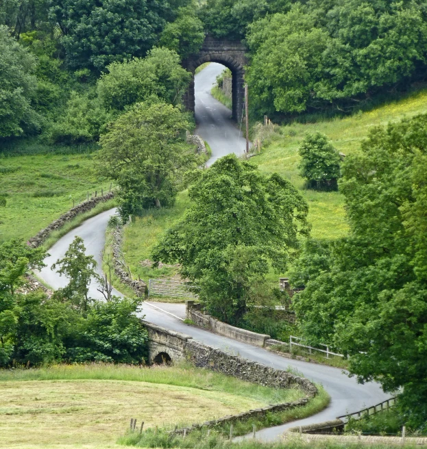 a scenic road in a valley and underpass on the side