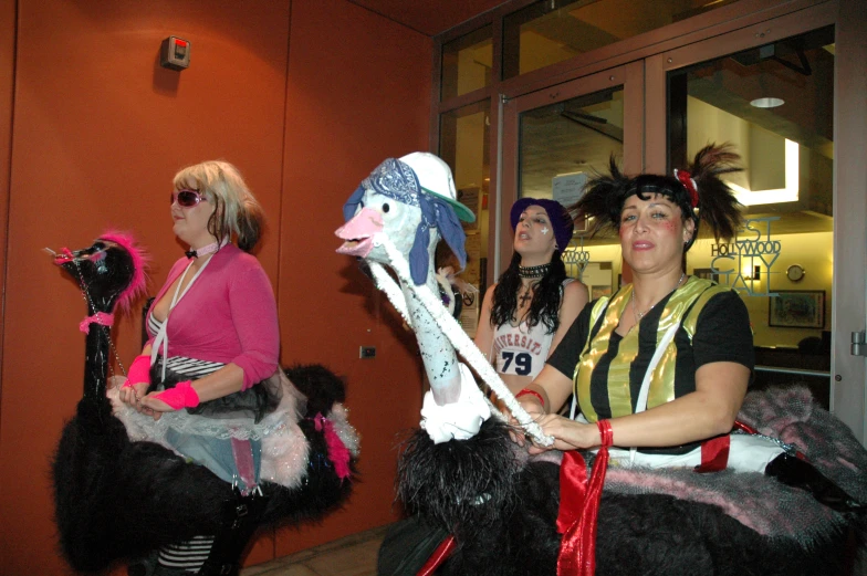 some women are sitting in the hallway while all dressed up