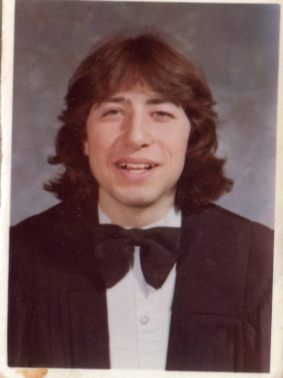 a man wearing a jacket and bow tie