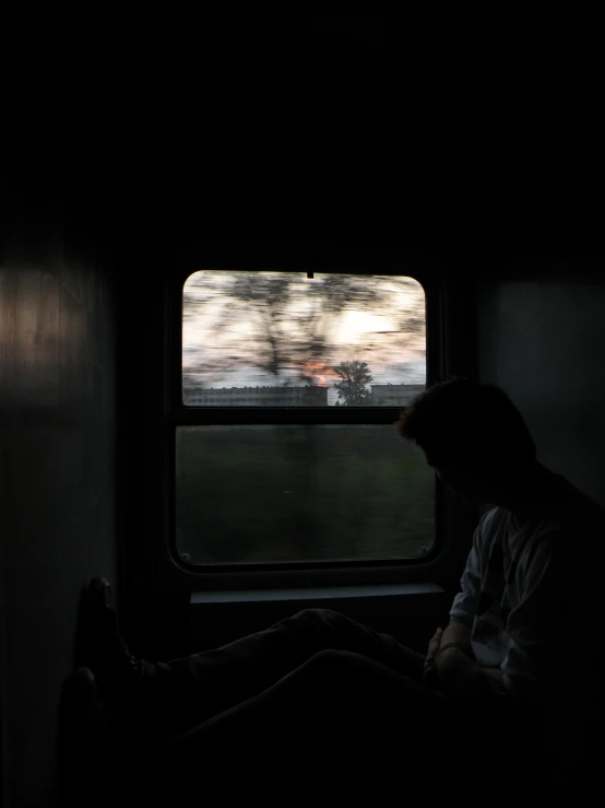 a person sits in front of a window