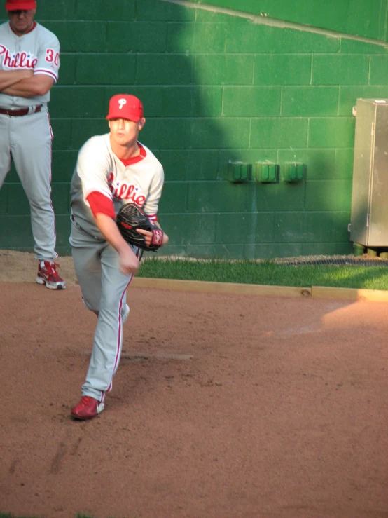 a baseball player winding up to pitch the ball