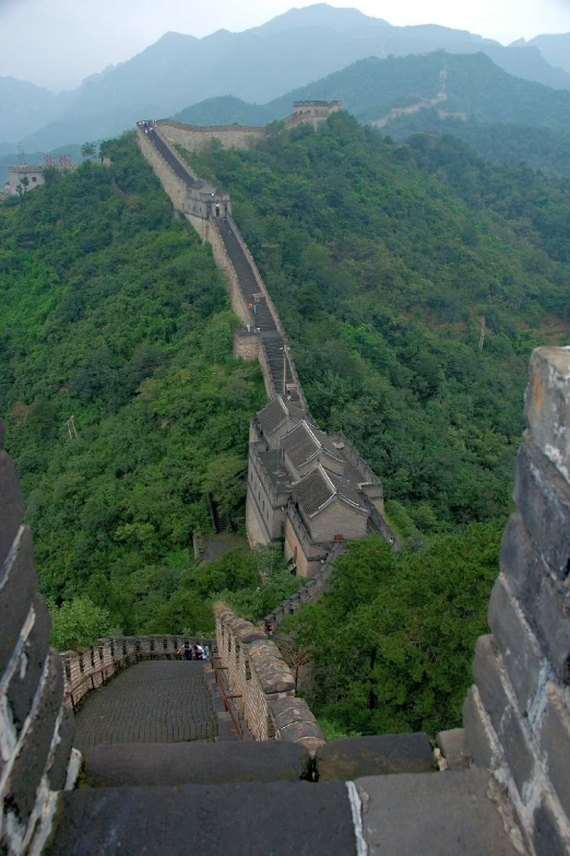 a large long wall with mountains in the background