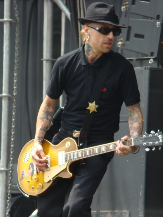 a male singer on stage holding his guitar