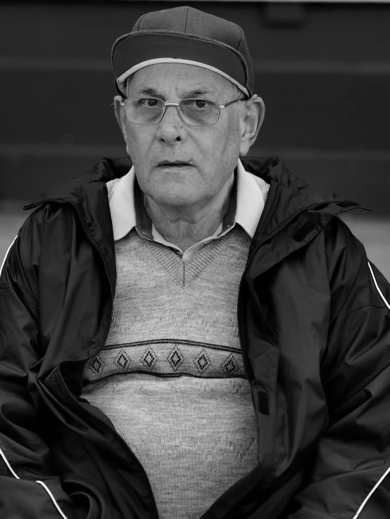 black and white po of older man with baseball cap