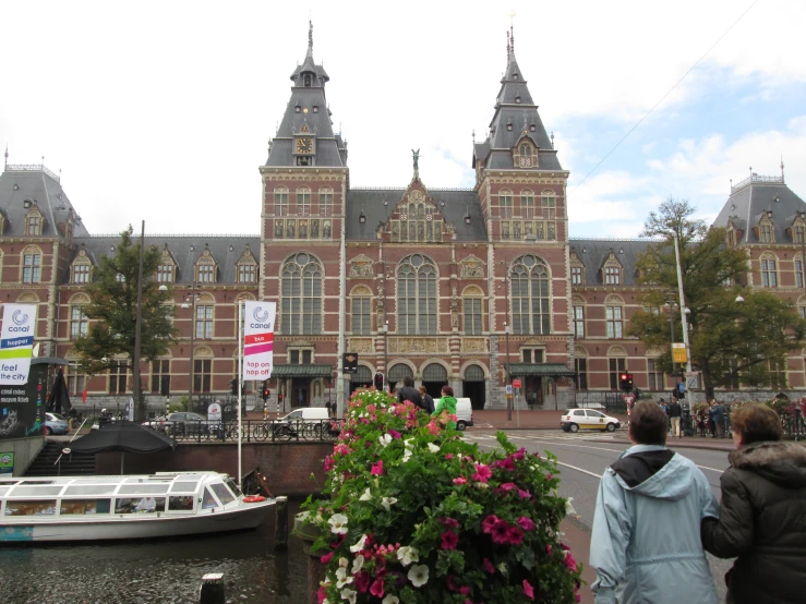 a large building with many windows and turrets is on the corner