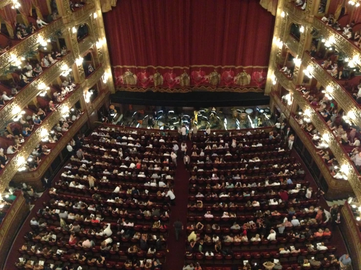 the auditorium of the theatre is packed with people