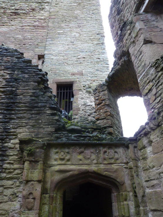 the gate to a castle in england has a window at each side
