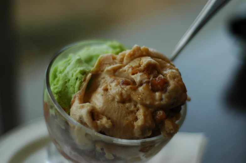 a glass bowl with ice cream on top