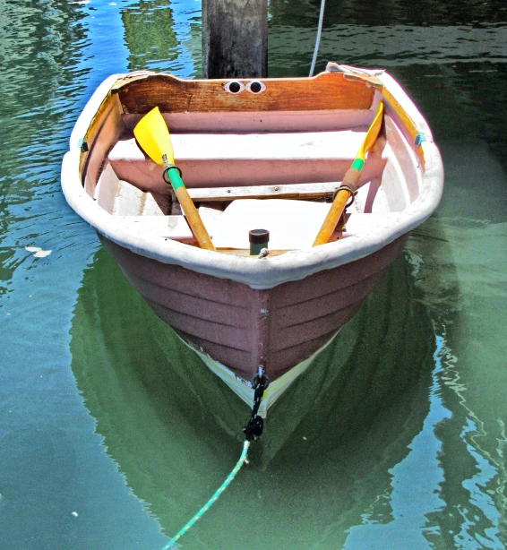 a small boat is docked at a wooden dock