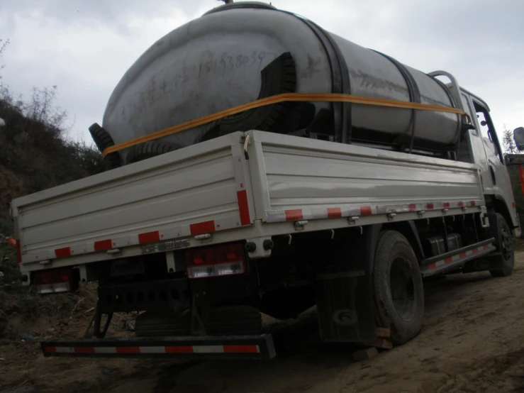 a large cement mixer parked next to an orange fence