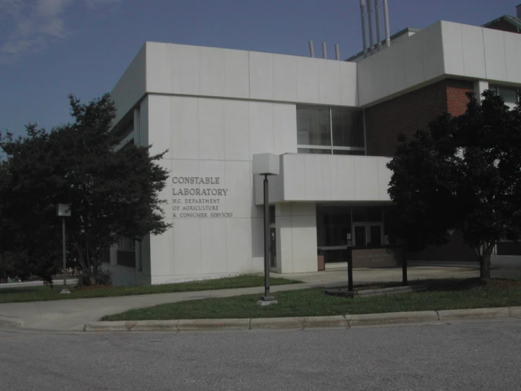 a building with large sign in front on the corner