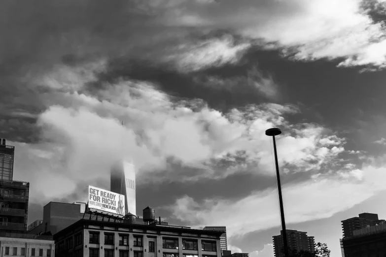 black and white pograph of city lights, street light and clouds