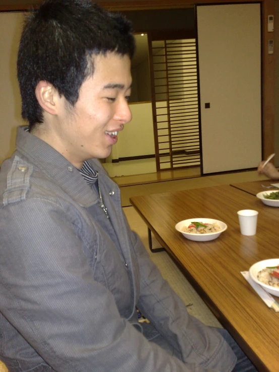 a man sitting in front of a table with food on it