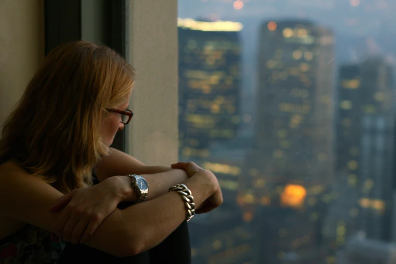 an image of woman in front of window overlooking city