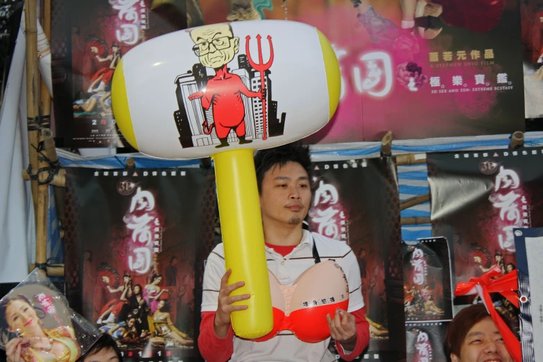 a man is holding up a large statue