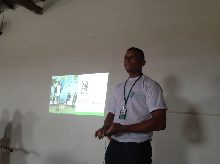 man standing in front of screen displaying large picture