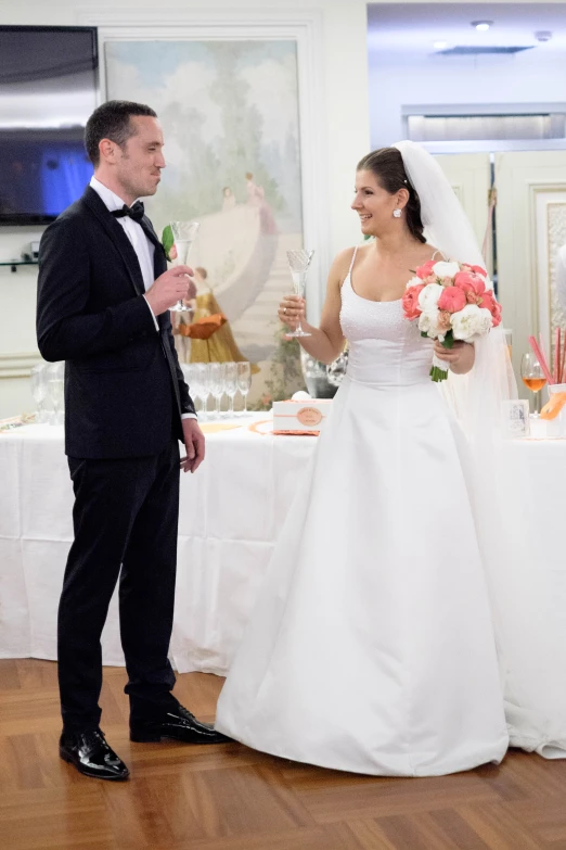 a bride and groom sharing a toast at a reception