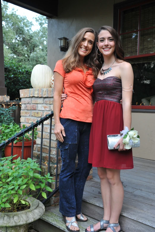 two women wearing sandals are standing on stairs