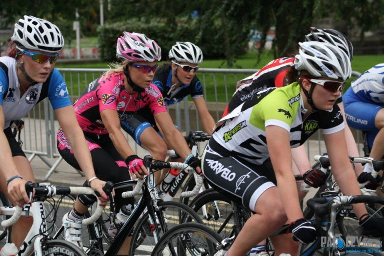 some people wearing helmets and bicyclists on bicycles