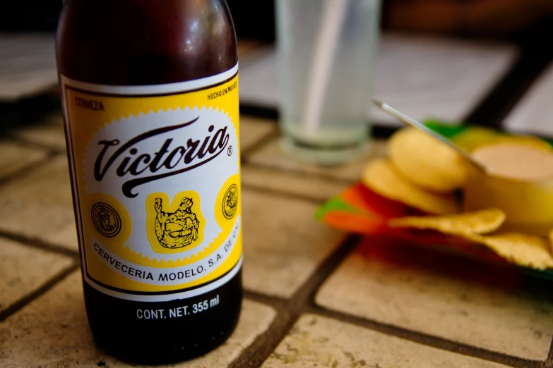 a bottle of alcohol sitting on a tiled counter