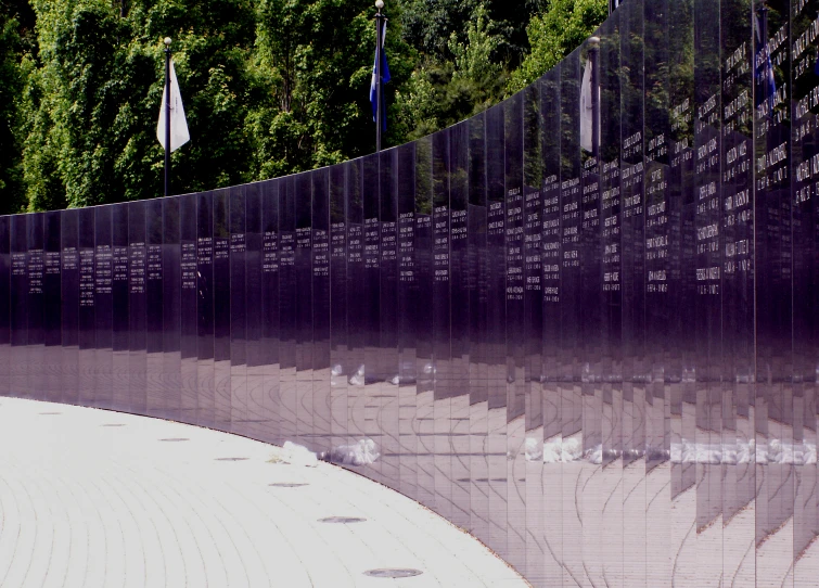 many names on the wall are written in a wide row