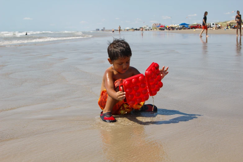 a  playing on the beach in the sand