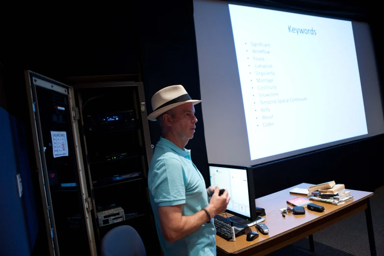 the man is showing the presentation at the table