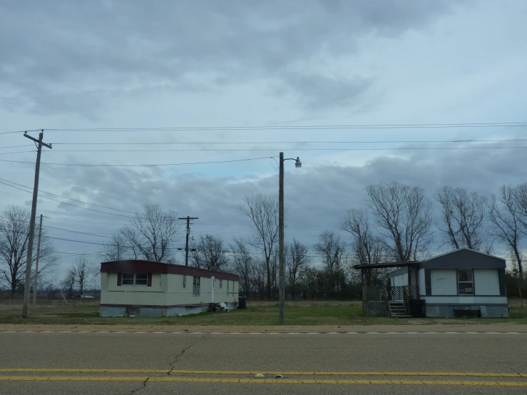 a small house sitting in the middle of an empty lot