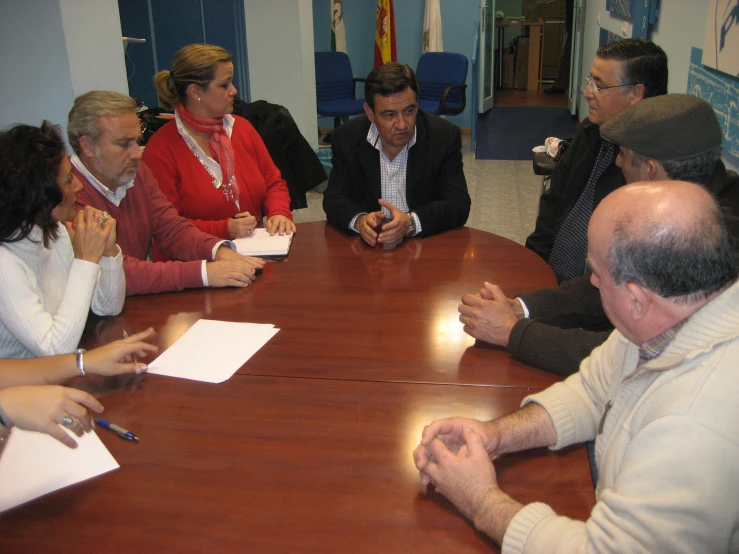 five people sitting at a table during an informal meeting