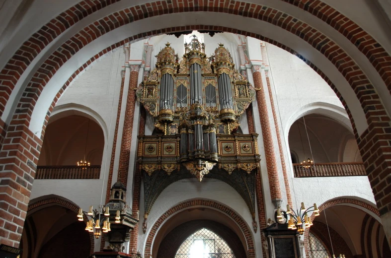 a large room with two ornate clocks and lights