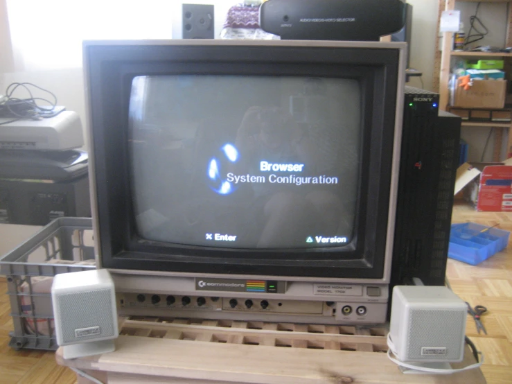 a black computer monitor on top of a wooden block