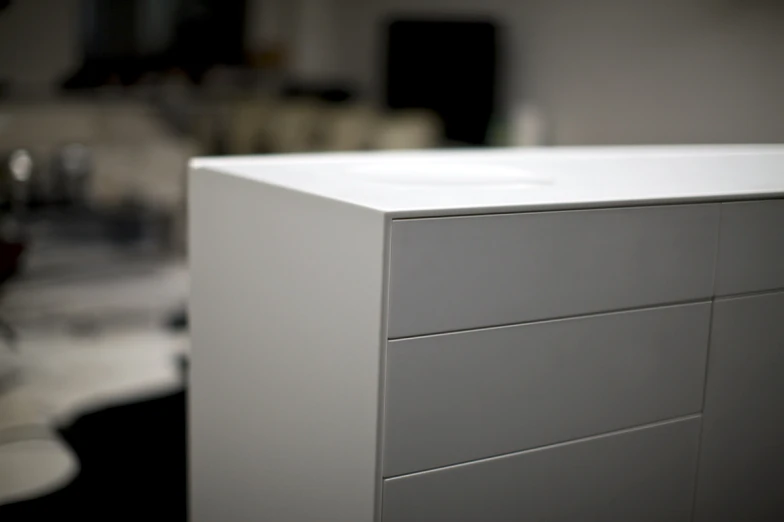 the front and back drawers of a white cabinet