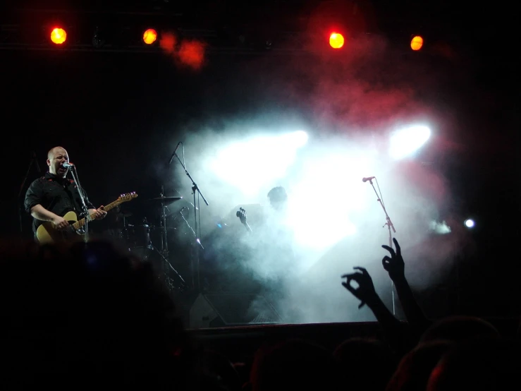 a person playing an acoustic guitar at a concert