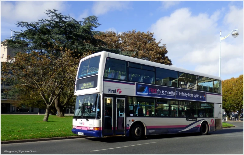 a double decker bus driving down a street