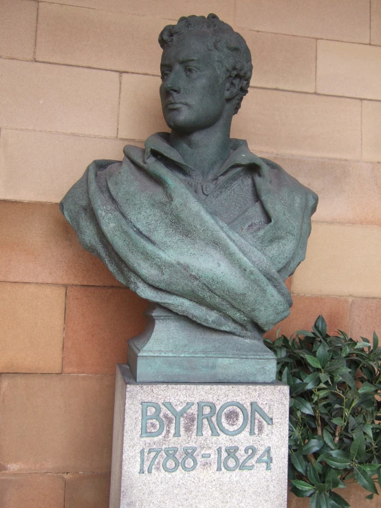 statue with a sign that says the birth of byron, 1876 - 1934