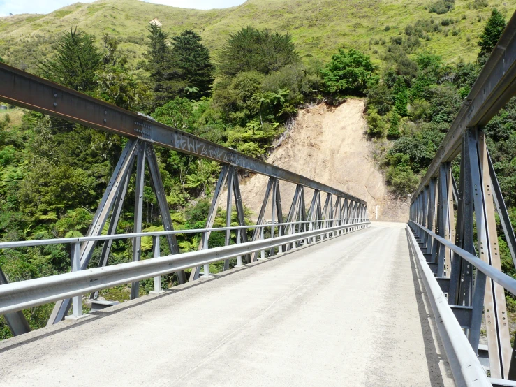 a long bridge is pictured on a narrow mountain side