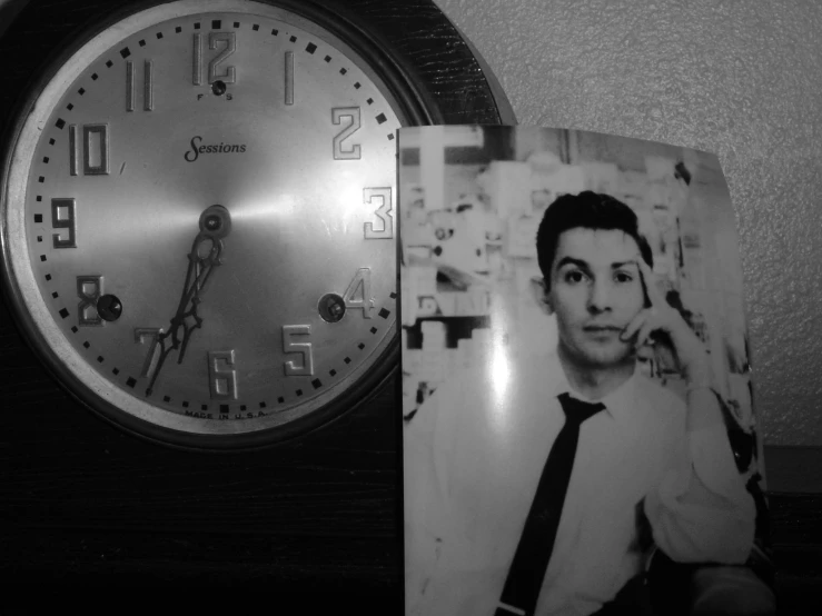 a clock with the face of a man with his hand on a po