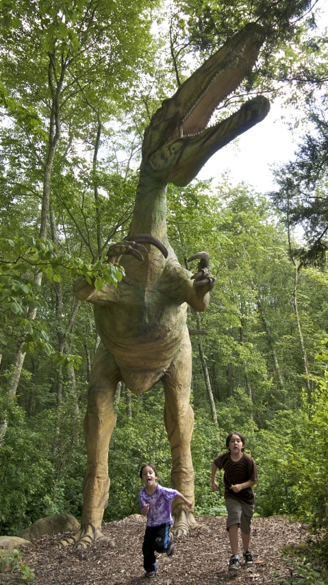 two people stand in front of a large sculpture