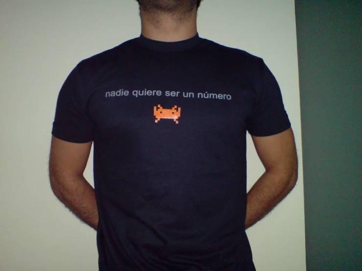 man in black t - shirt with an orange cat on the screen