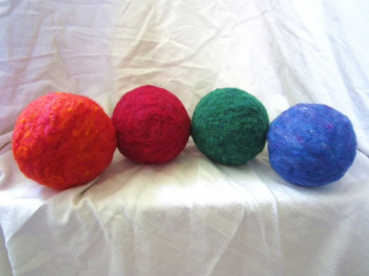 a close up of three different types of yarn balls