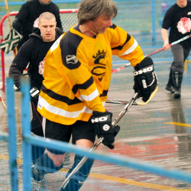 some men wearing uniforms playing some ice hockey