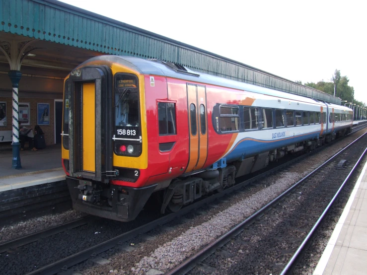 an open door is on a train at the station