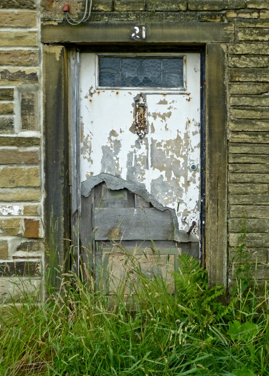 there is an old door and side of a building