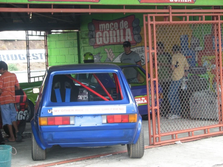 the car parked in front of the building is covered with red paint