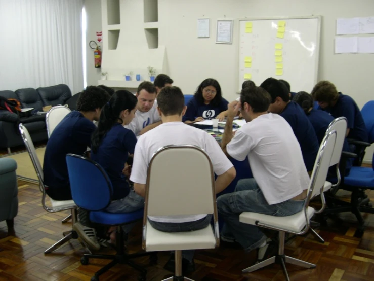 a group of people sitting at round tables