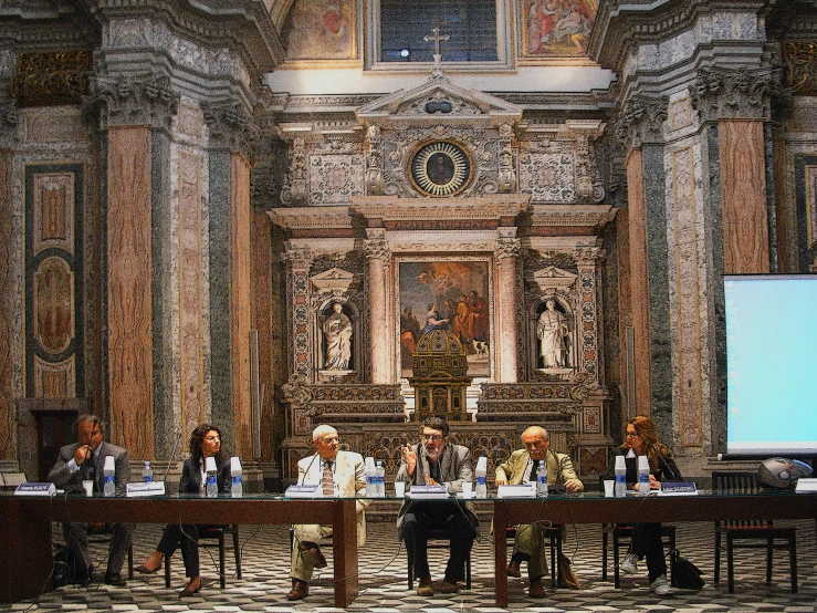 a group of people are sitting at a table