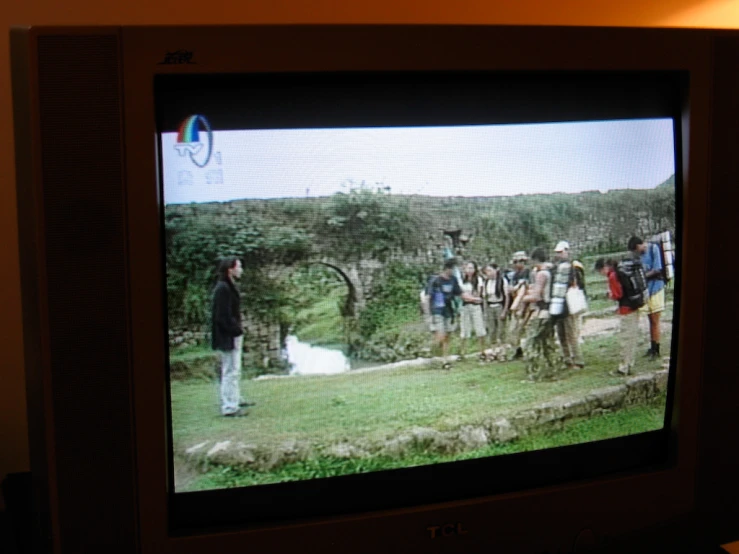 a group of people standing around on a tv