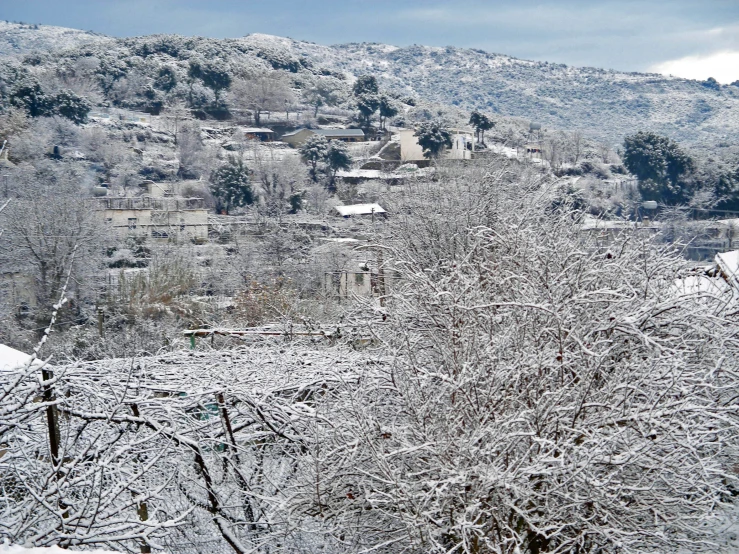 a small cabin on a snowy hill next to the town