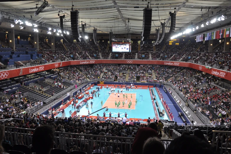 an inside view of a crowded volleyball court