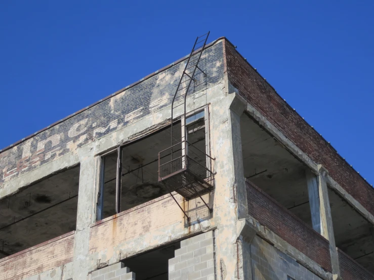 a building with a window and some fire escape stairs